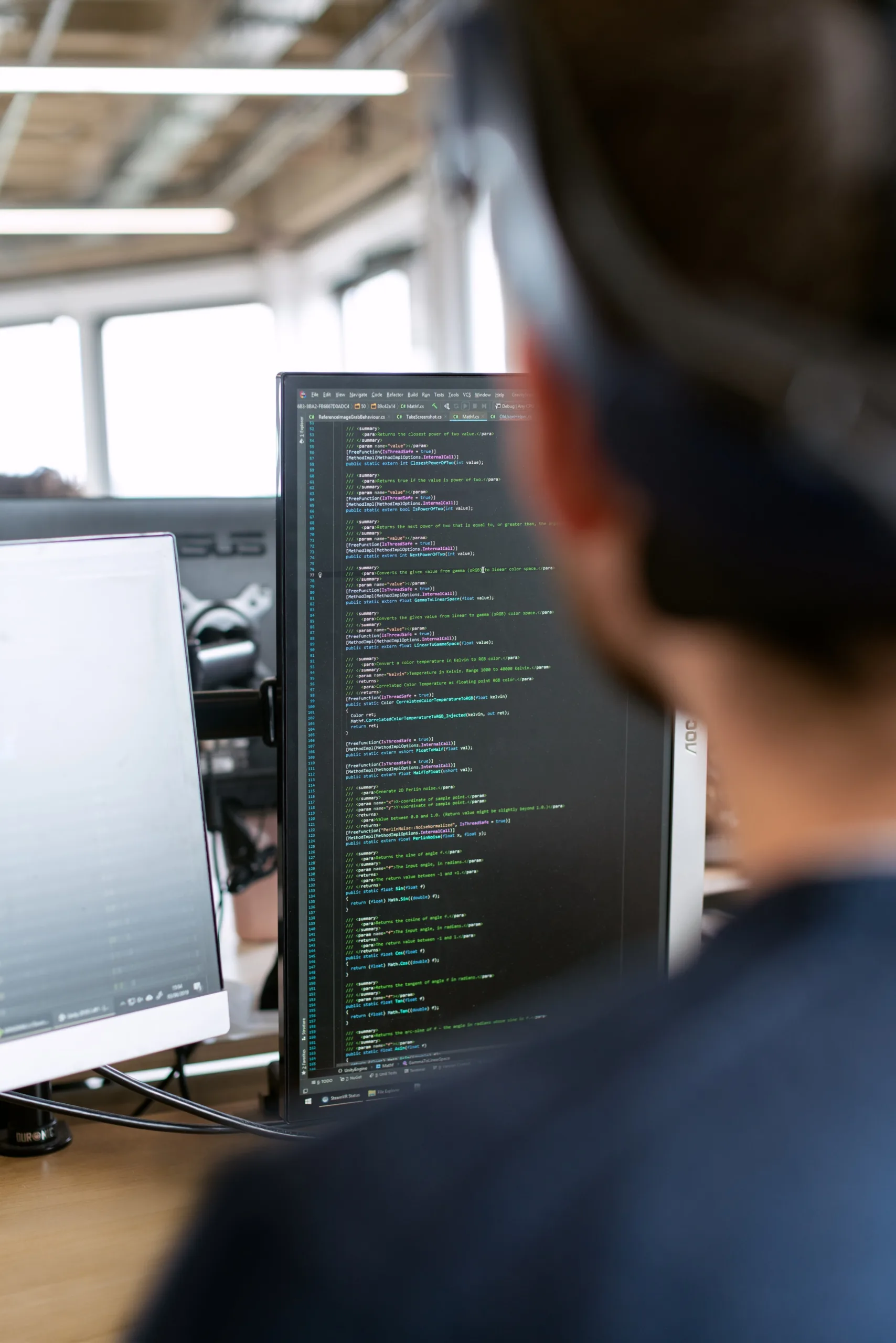 An engineer coding in front of a screen
