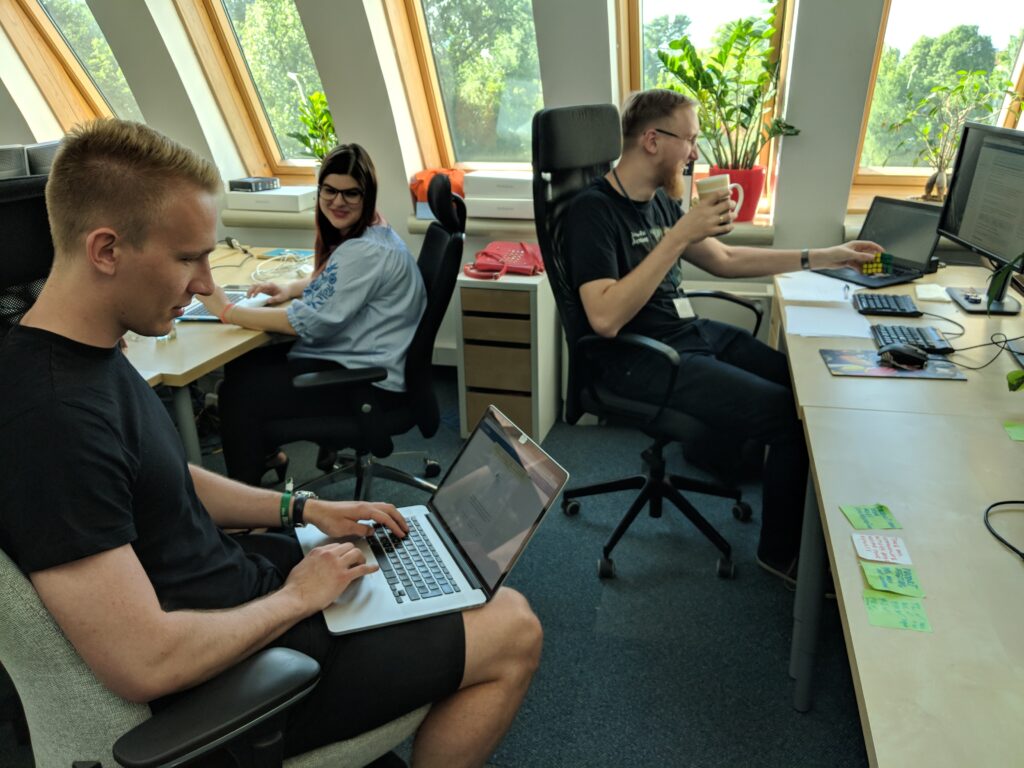 Colleagues in an office in front of their laptops.