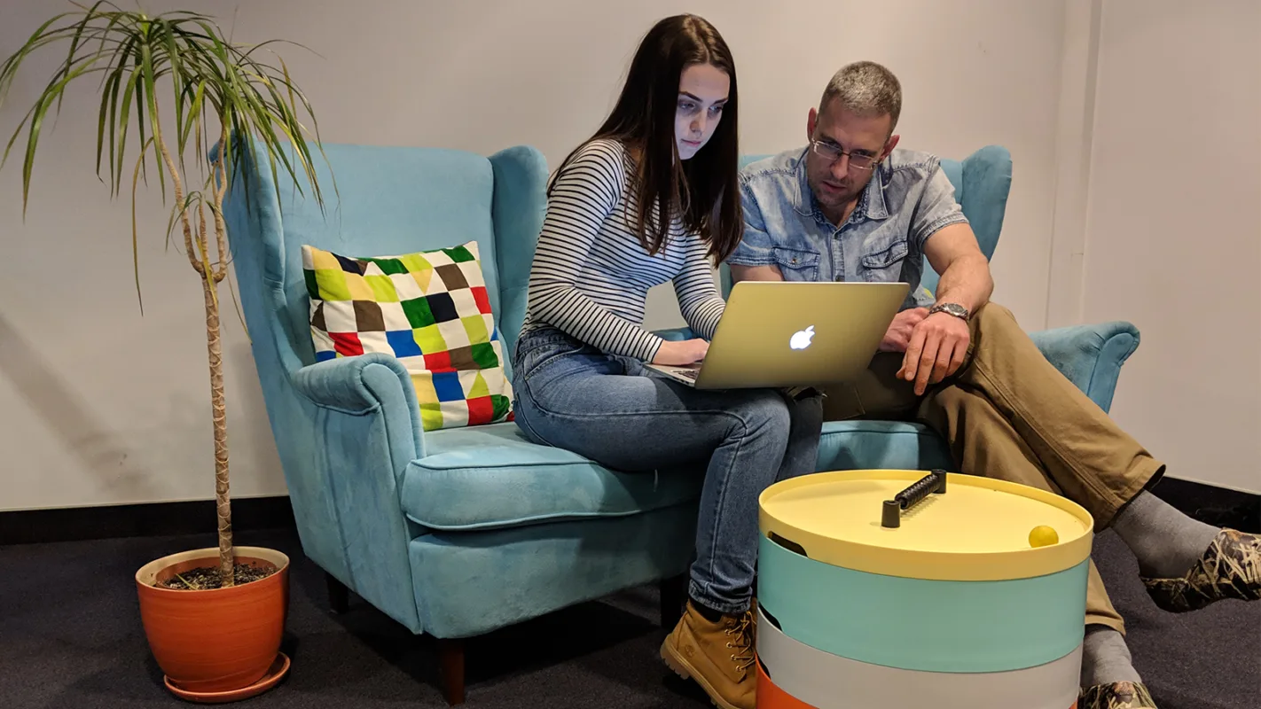 Colleagues in front of a laptop