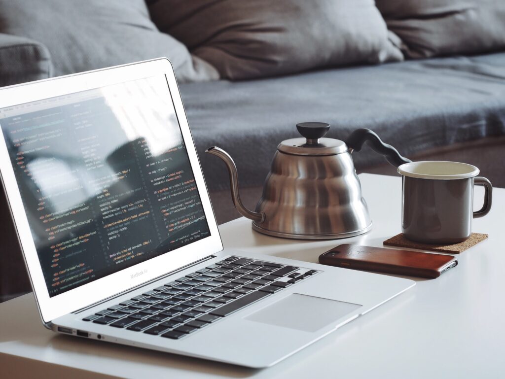 Laptop with code on a coffee table. 