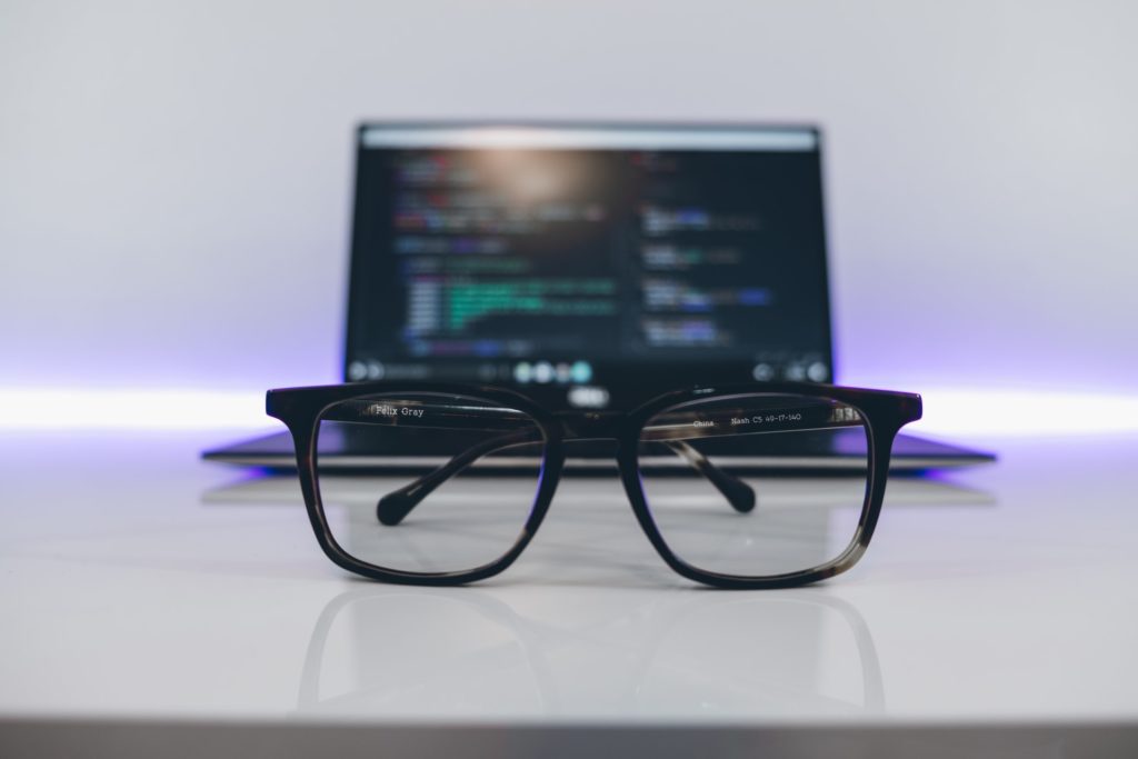 Glasses in front of a laptop.