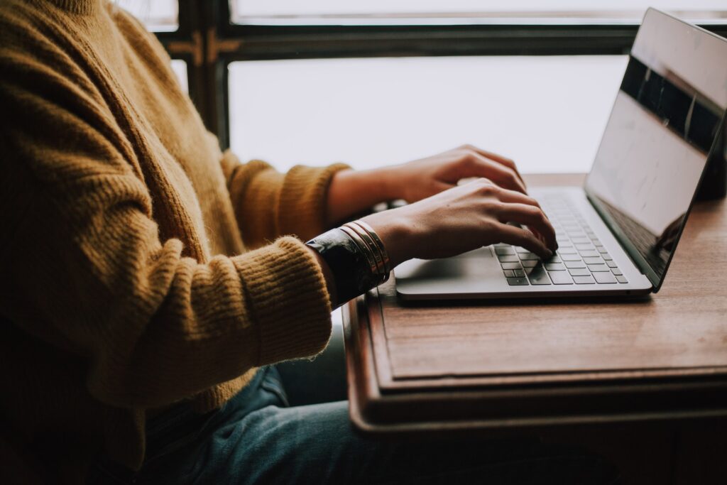 Deliver first-class candidate experiences with remote hiring Person at a desk in front of a laptop