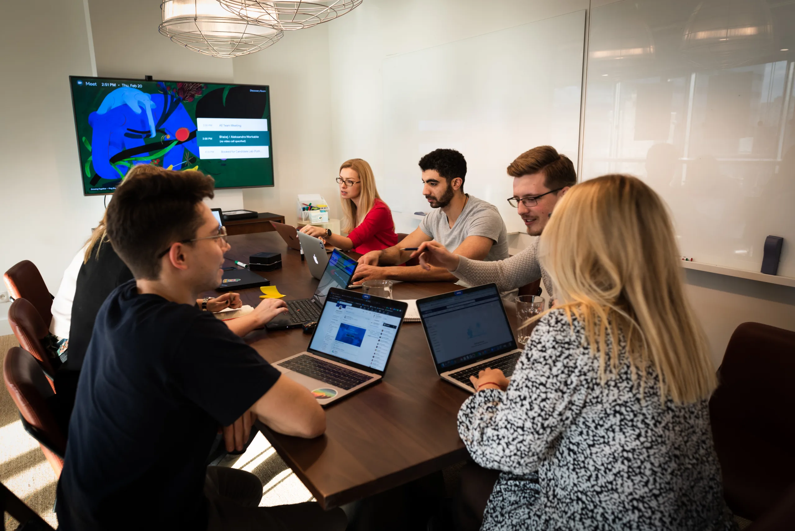 engineering team in a conference room solving a problem