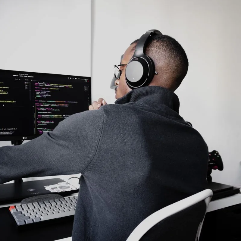 black man in front of IDE and code screen